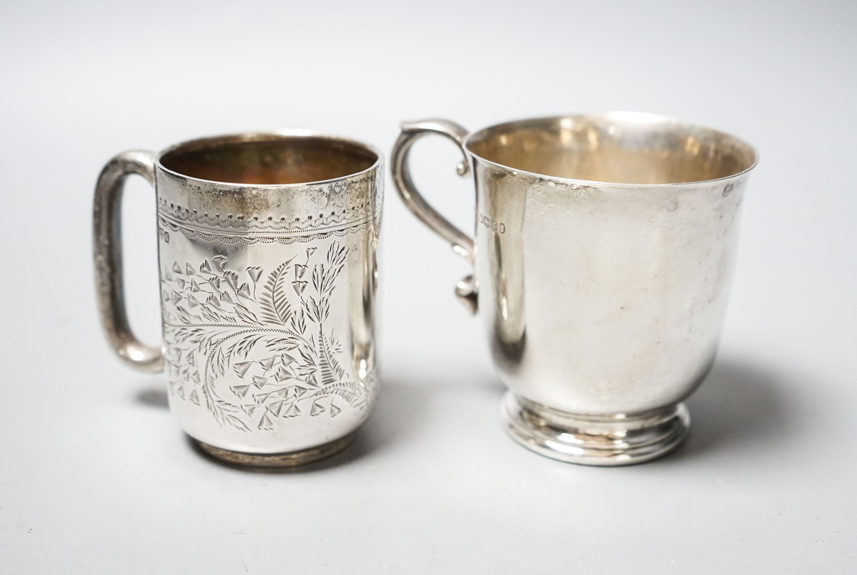 An Edwardian engraved silver christening mug, Chester, 1906, 73mm and a later silver mug, 6.5oz.